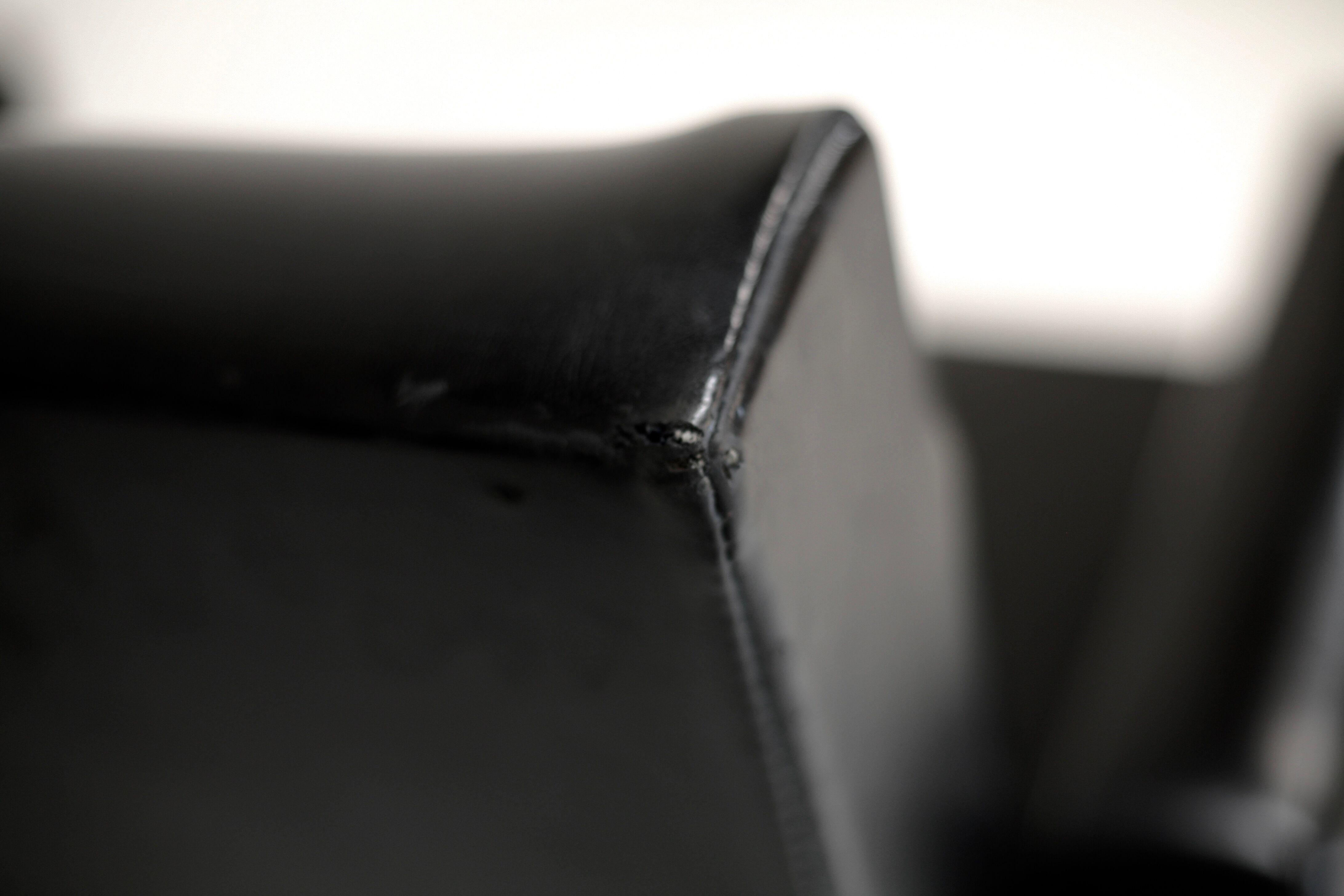 Pair of stainless steel, black leather-like armchairs, France, circa 1970