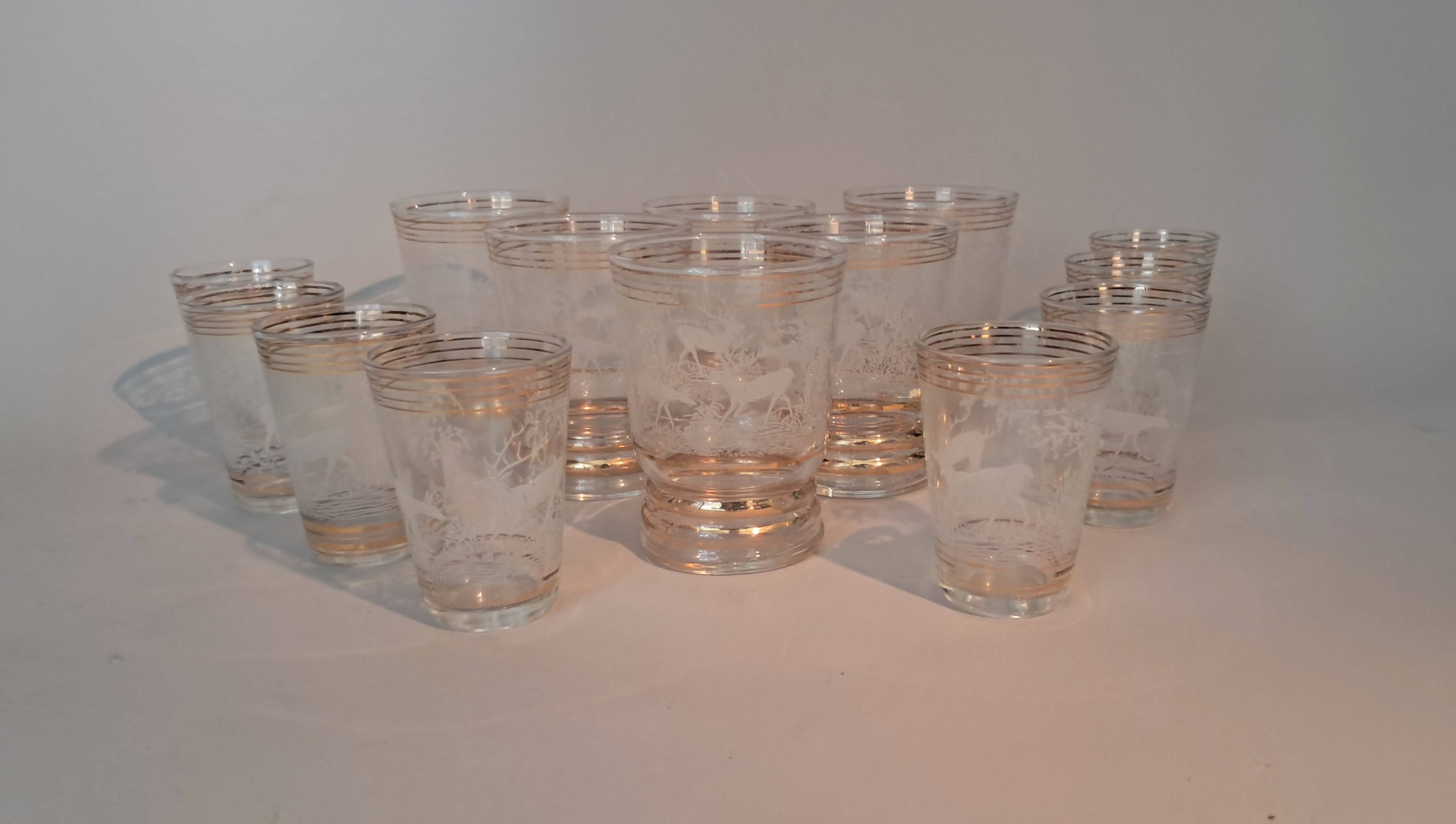 Service of 14 gold-plated and engraved glasses with a deer in the woods design from 1950