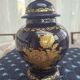 Cobalt blue porcelain bonbonnière with gold decoration on feet.