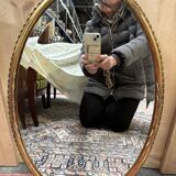 Oval mirror in gilded wood