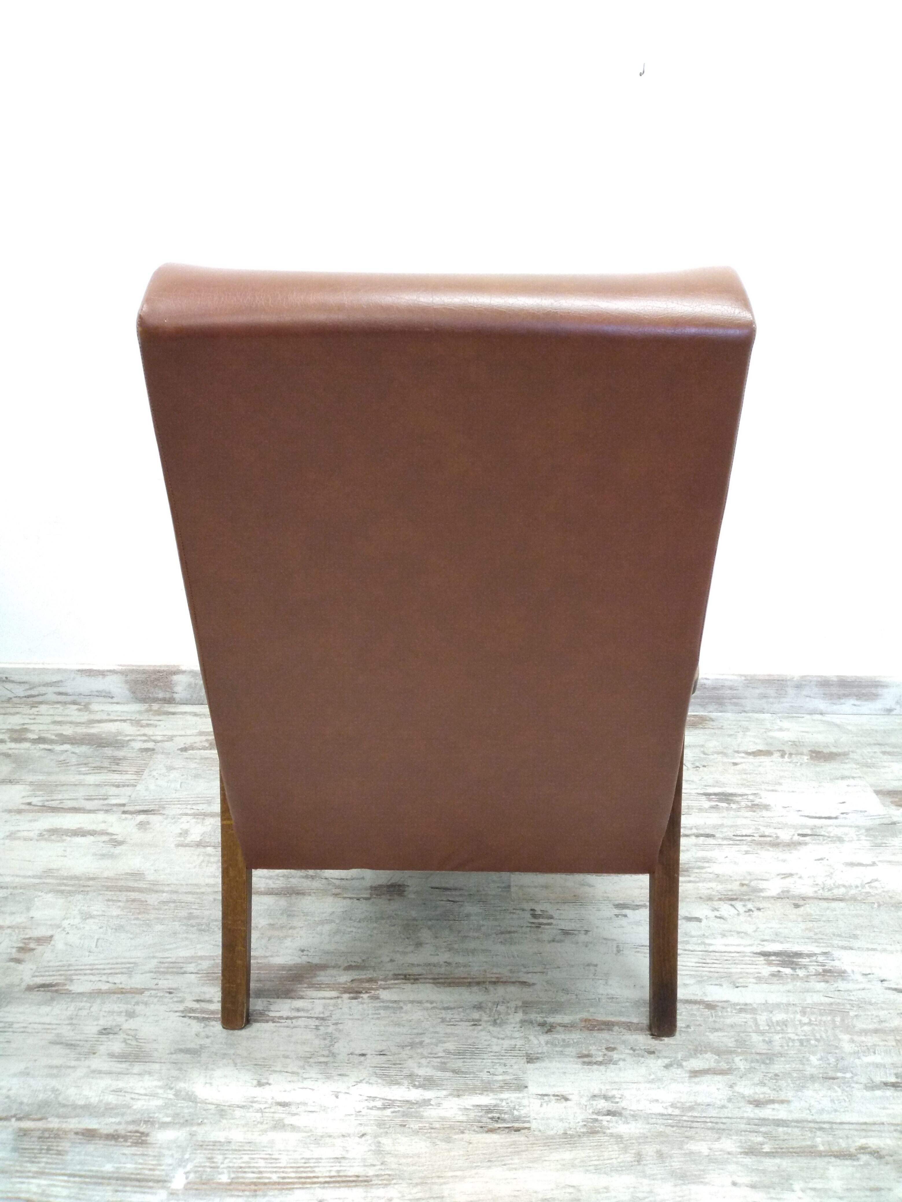 Vintage armchair in wood and imitation leather