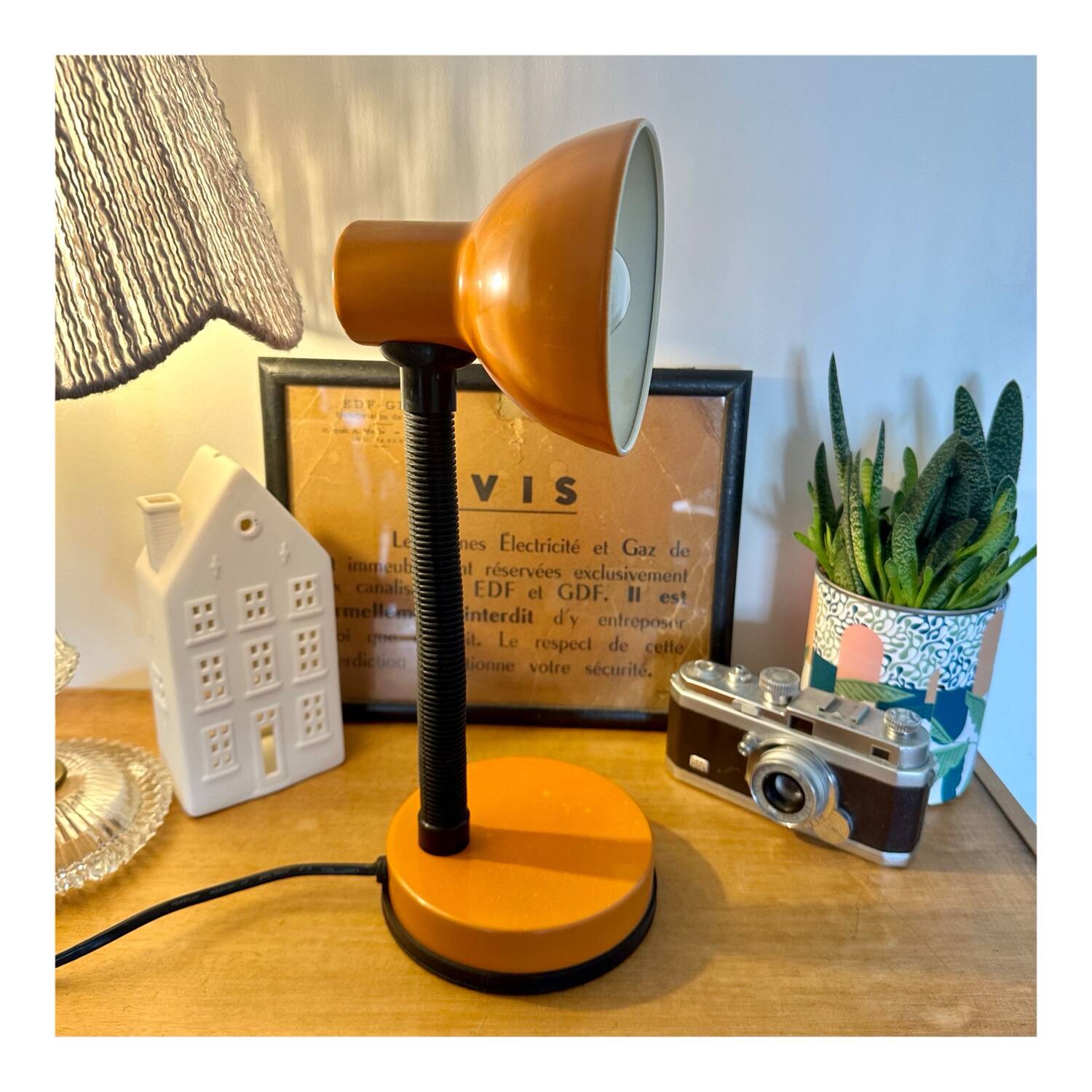 Orange articulated desk lamp