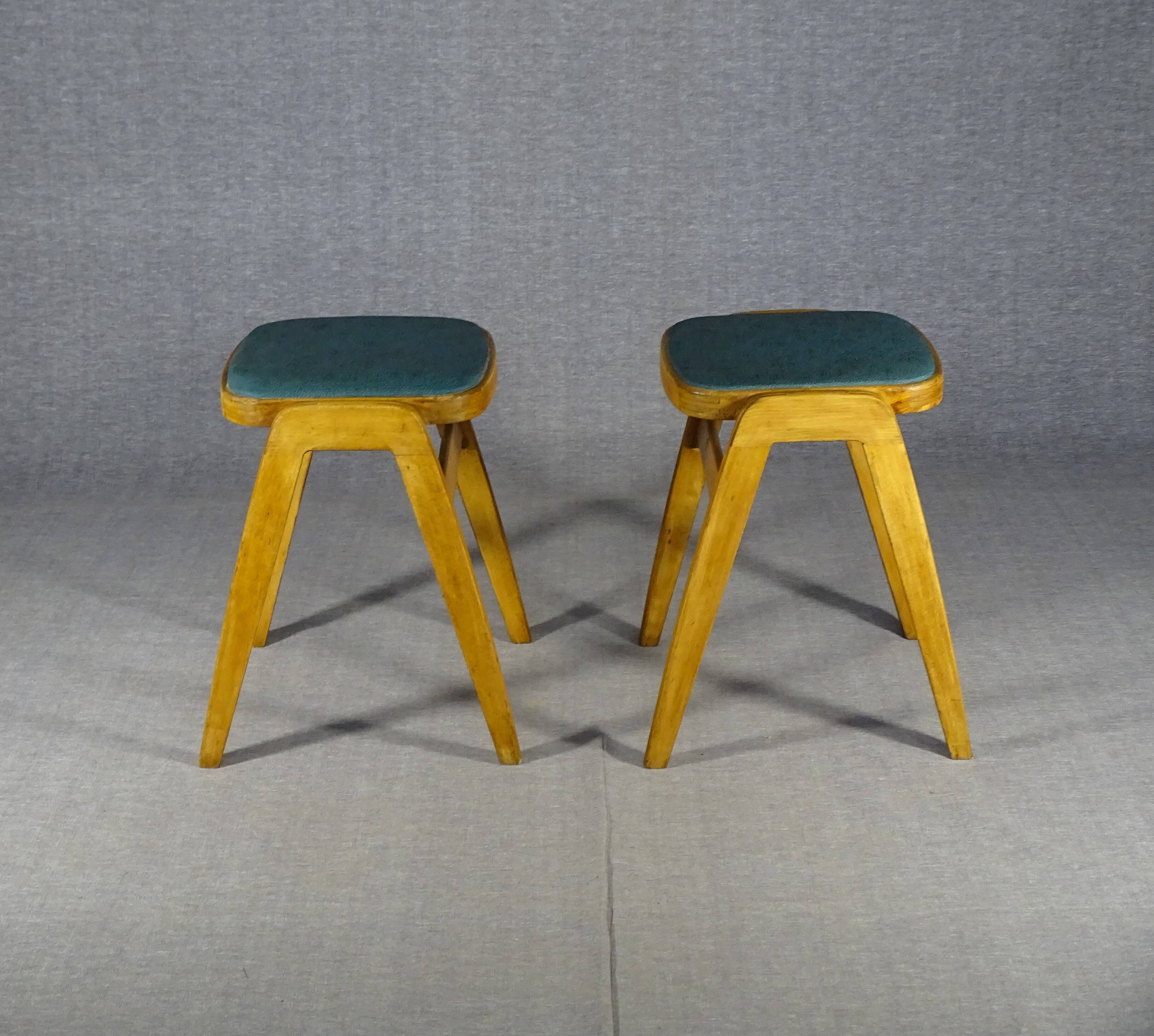 Two MID-Century green vinyl stools from the 1970s with tapered legs.
