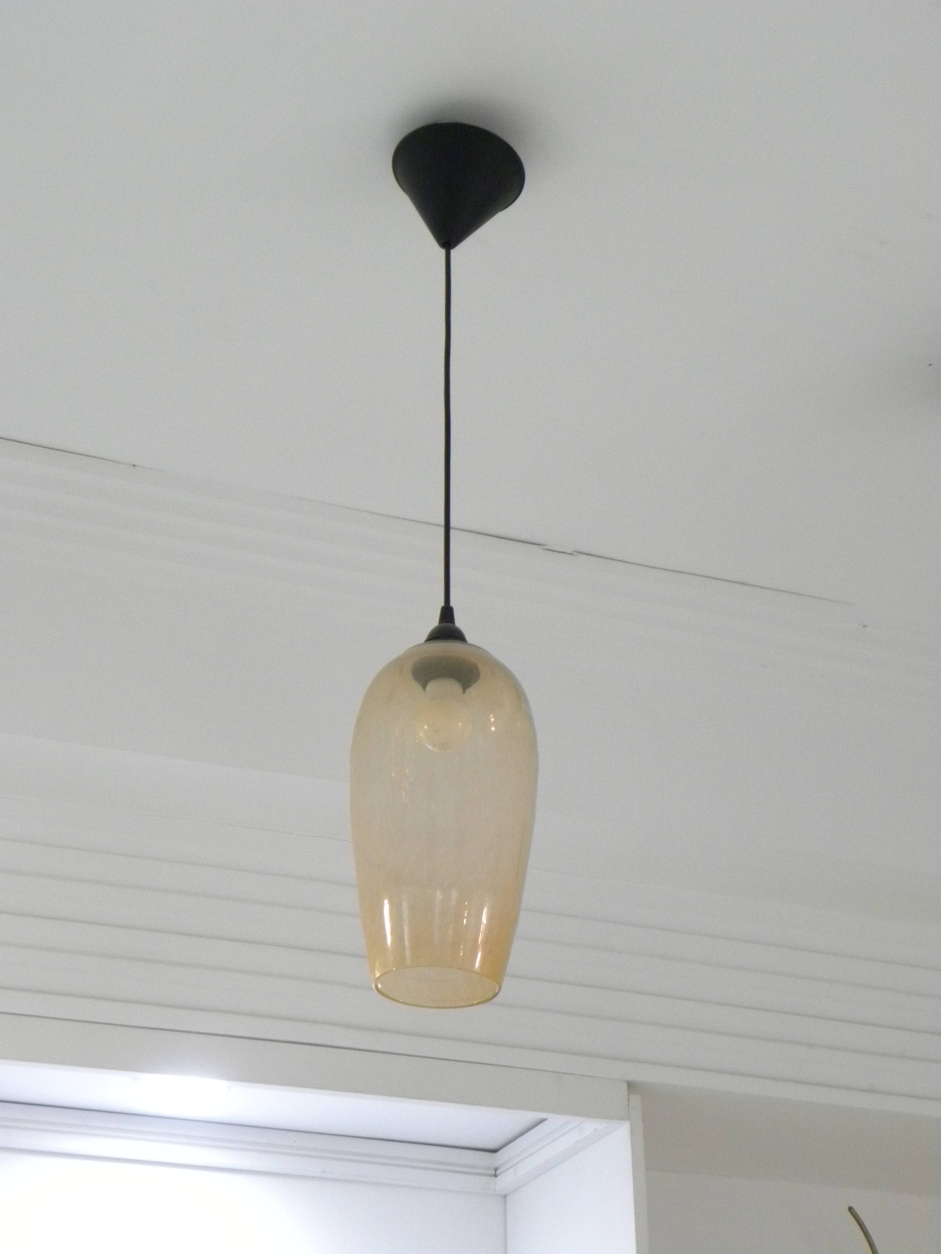Amber glass suspension light, warm modern interior lighting.
