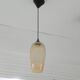 Amber glass suspension light, warm modern interior lighting.