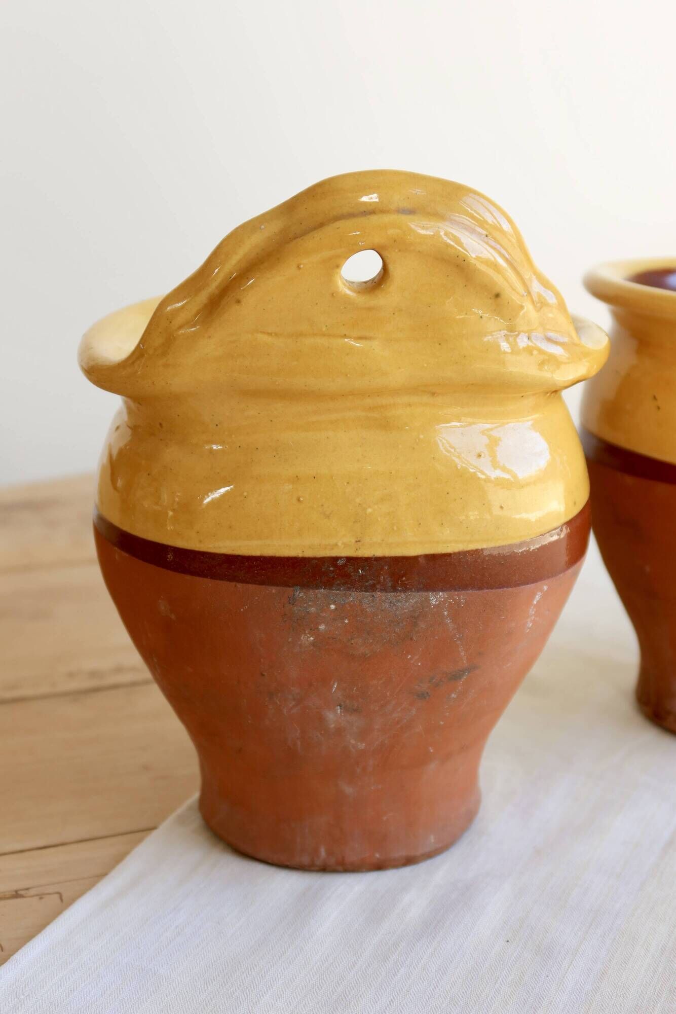 Pair of vintage wall planters in yellow glazed stoneware.