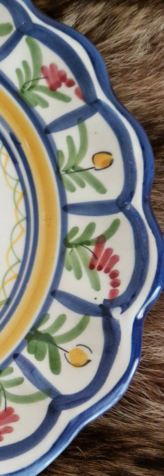 Large hand-painted French faience plate with floral decoration in folk art style.