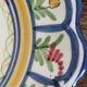 Large hand-painted French faience plate with floral decoration in folk art style.