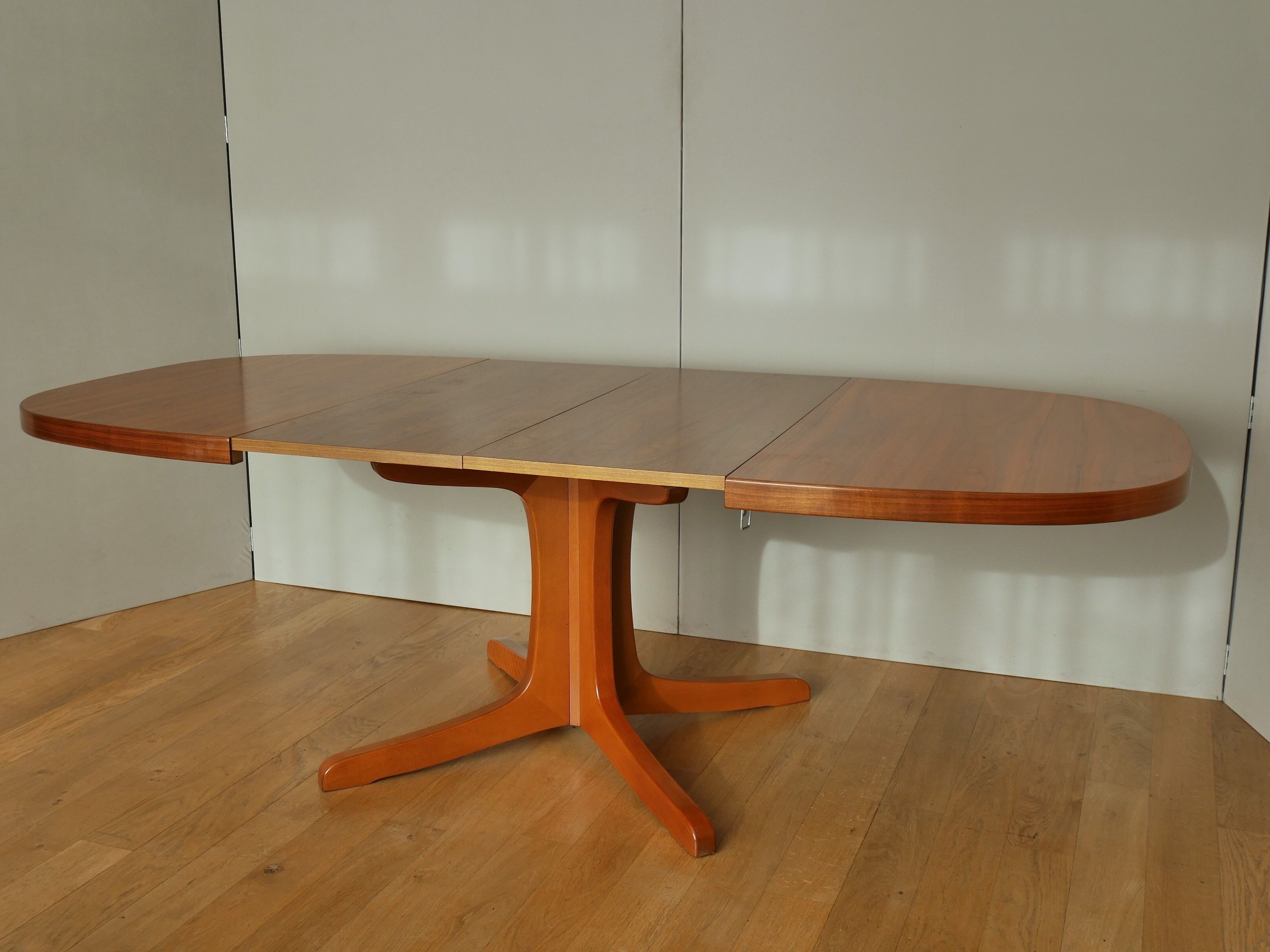 Oval walnut table with extension cords