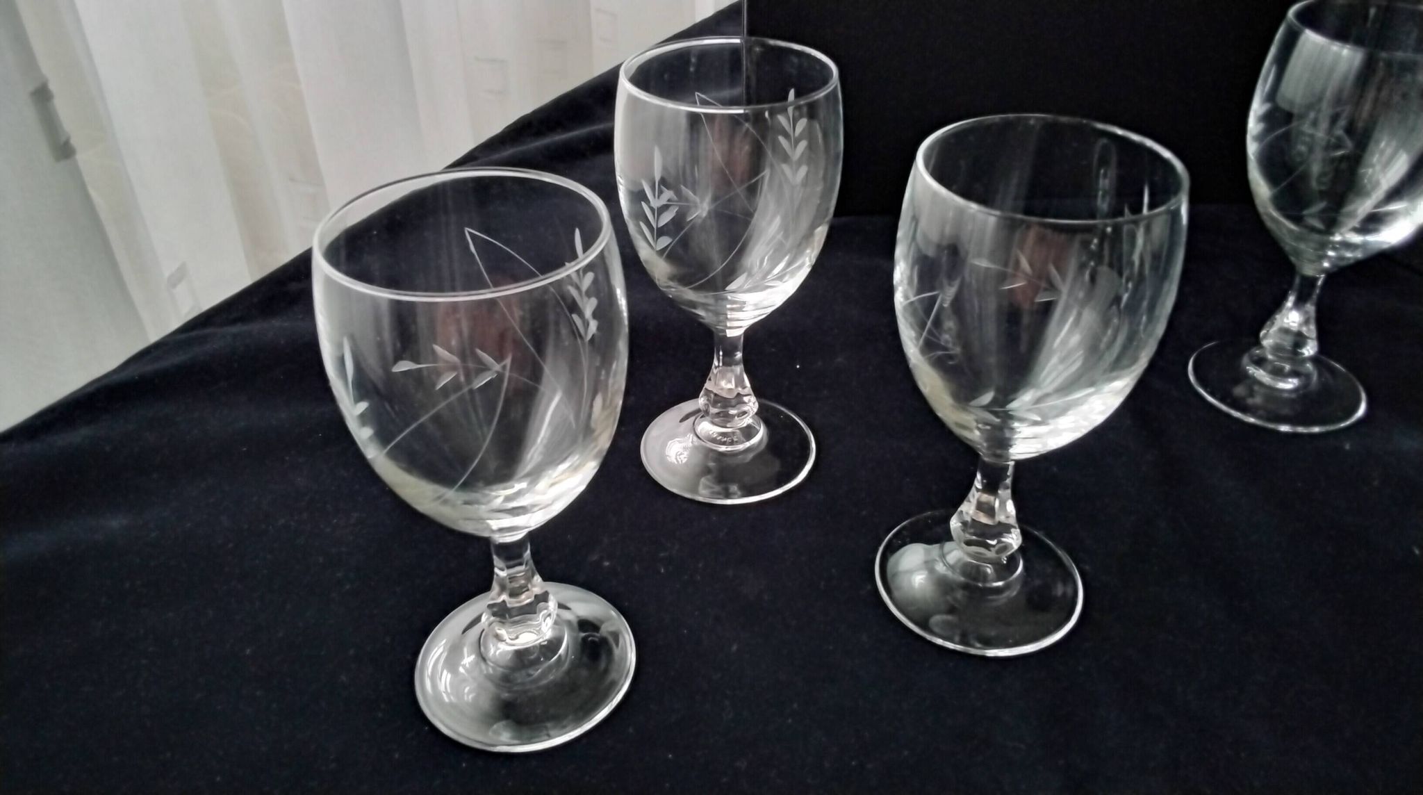 6 vintage wine glasses with baluster stems and engraved decoration on the bowl.