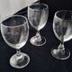 6 vintage wine glasses with baluster stems and engraved decoration on the bowl.