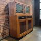 Vintage Art Deco display cabinet in wood with green stained glass.