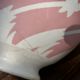Old footed bowl in earthenware with pink decoration and defects.