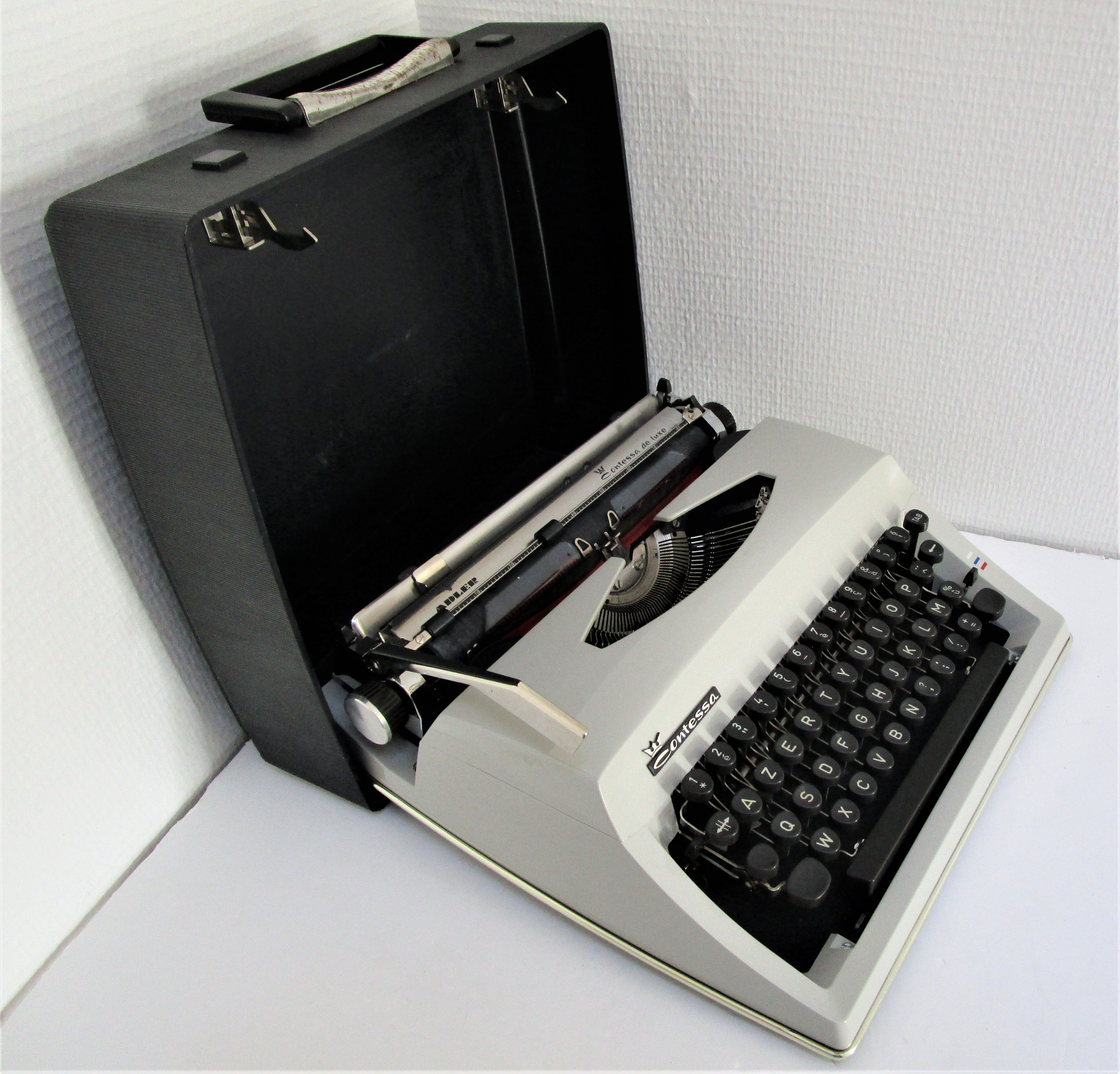 Writers' typewriters of light grey 70s Adler made in Holland