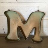 Golden sign letter "M"