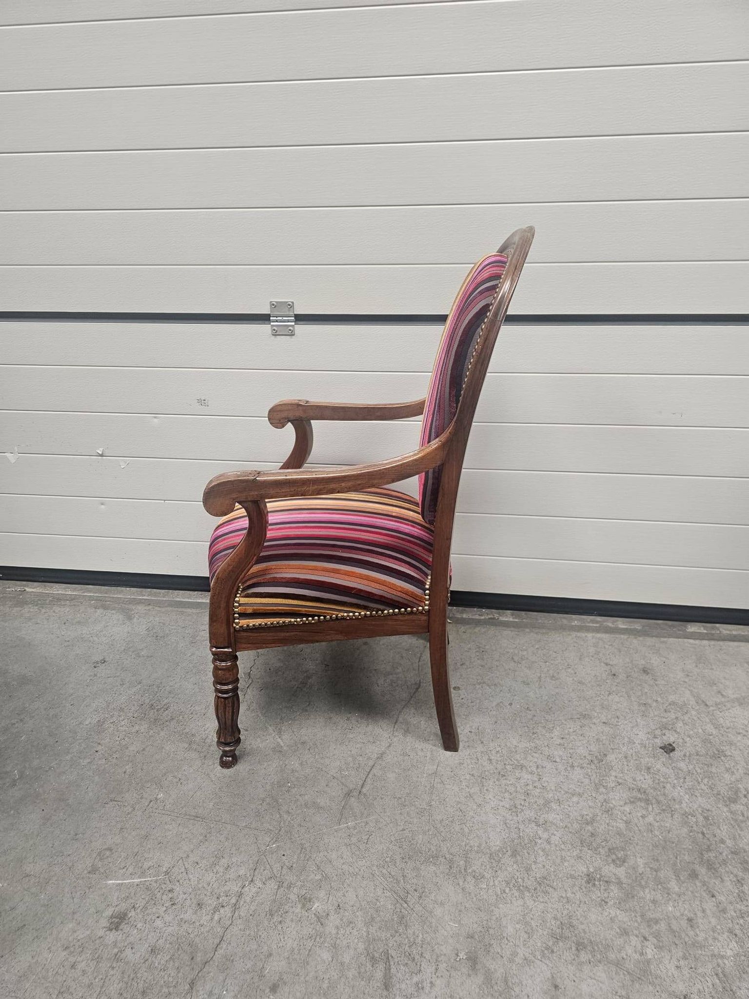 Antique striped multicoloured velvet armchair with turned legs.