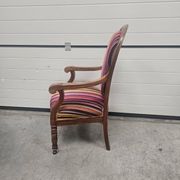 Antique striped multicoloured velvet armchair with turned legs.