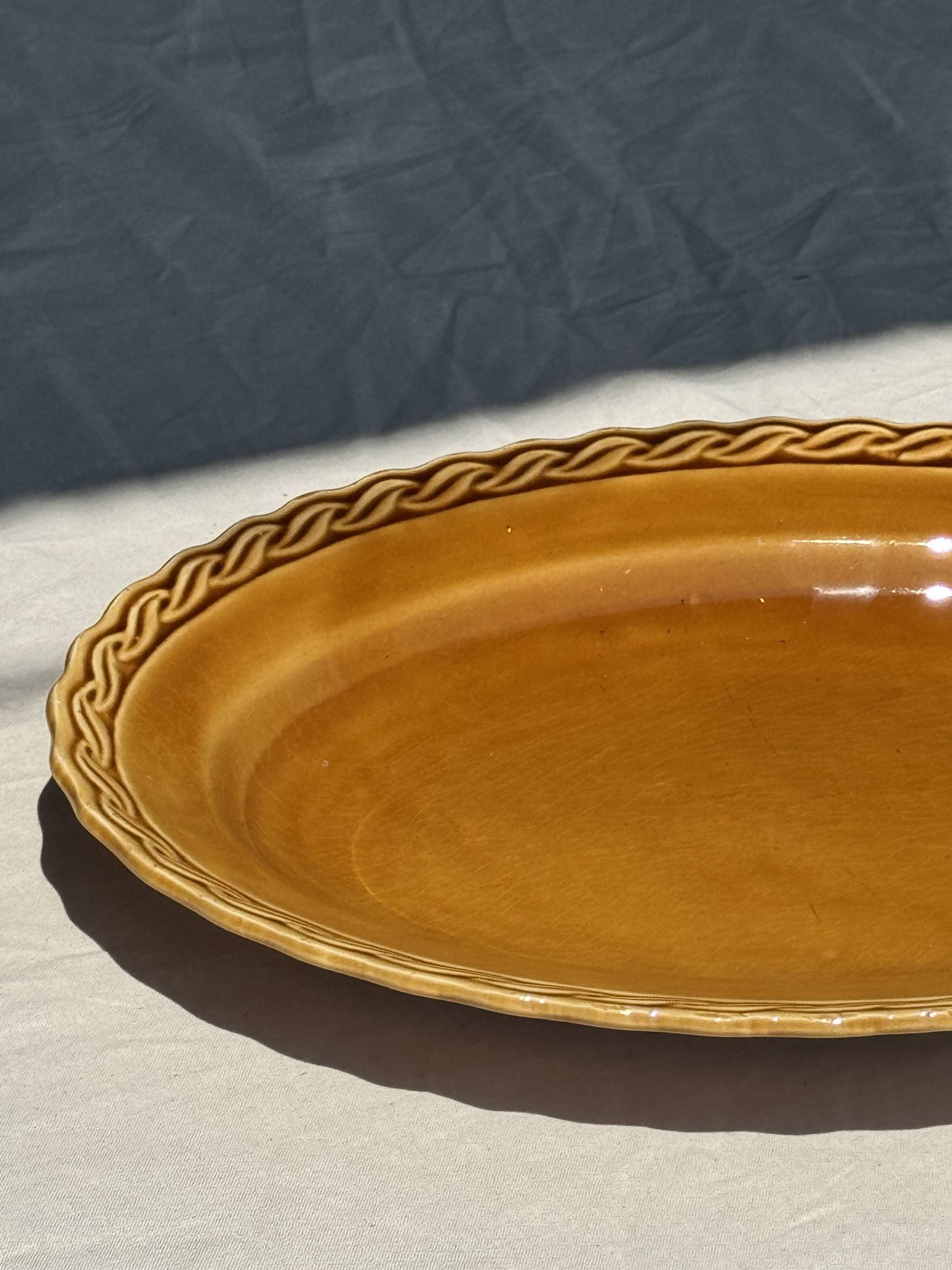 Antique oval dish, yellow-orange, frieze border L:24