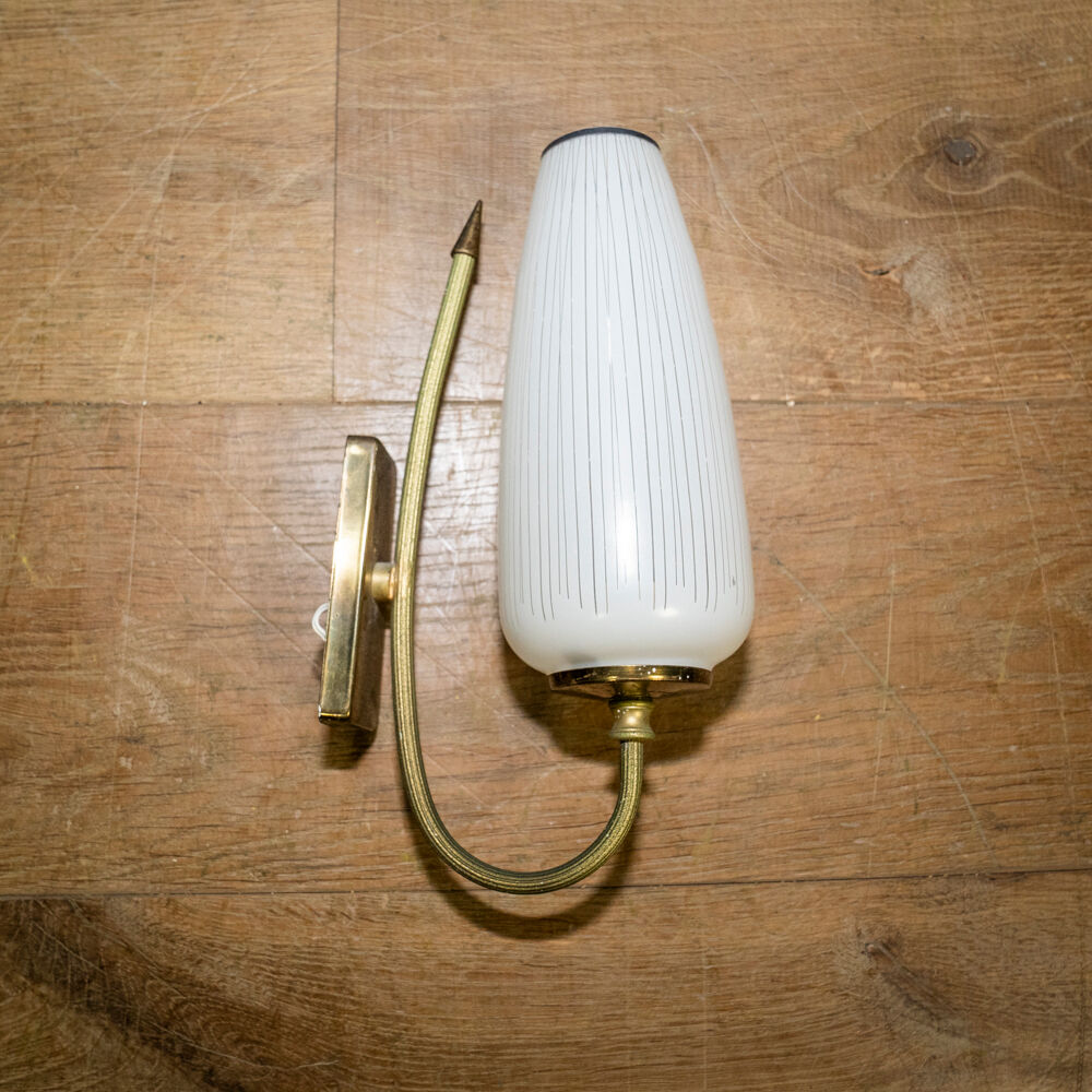 Ornate wall lamp made of milk glass and brass
