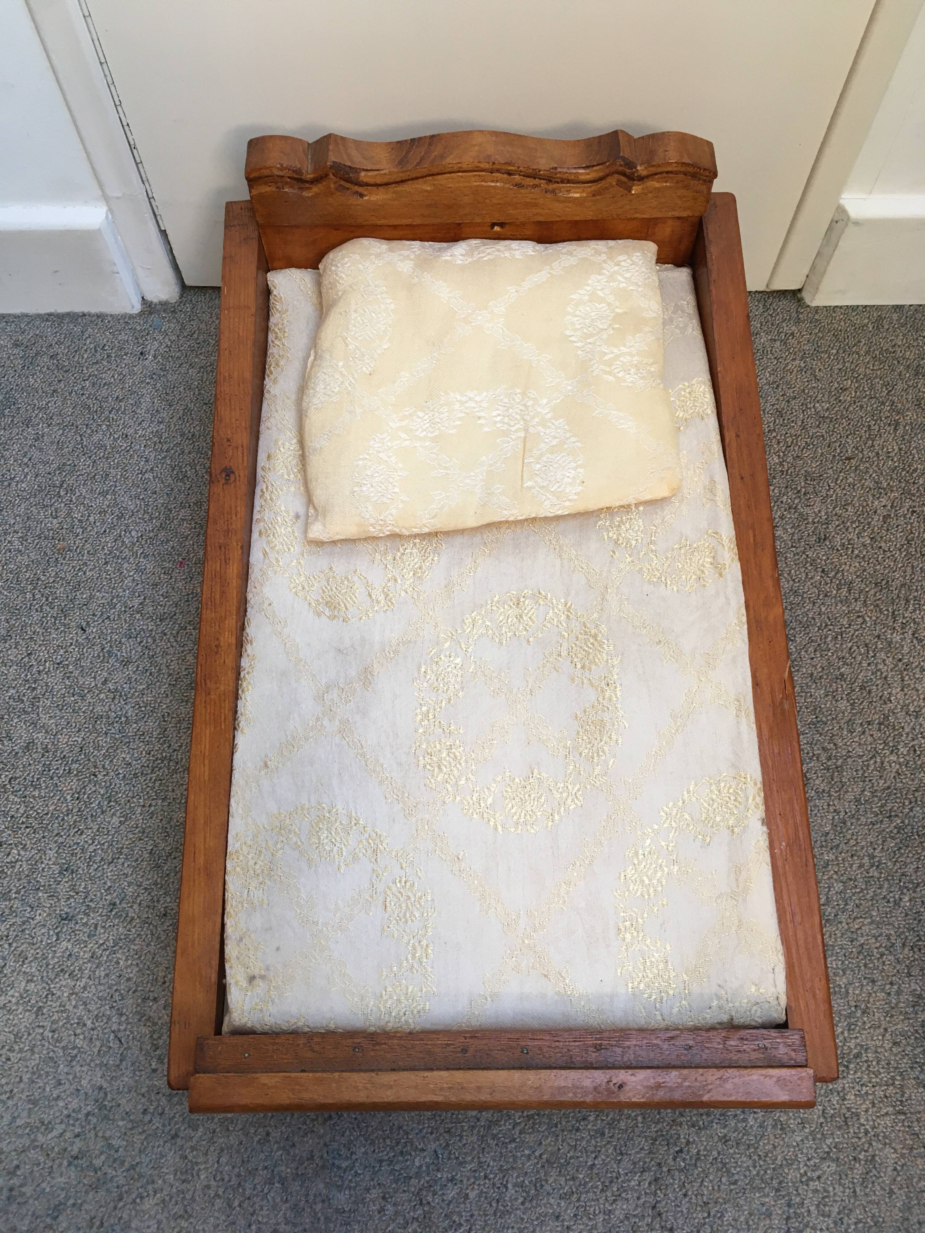 Old wooden bed for doll with mattress and pillow
