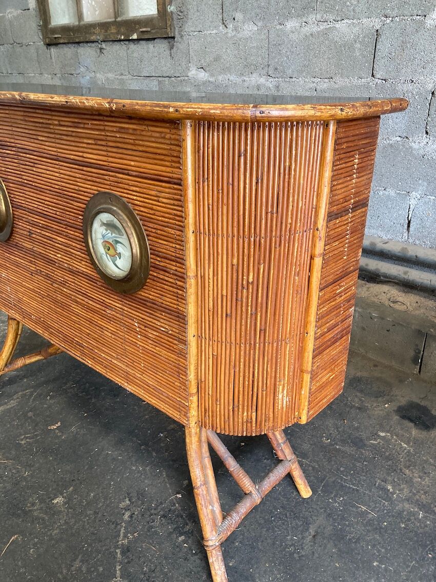 Rattan and wood bar with its decorative brass portholes