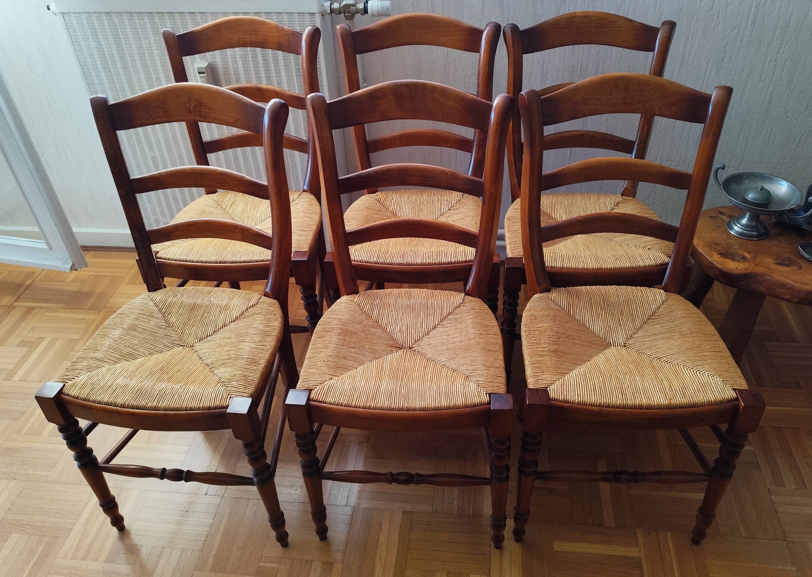 Set of 6 solid wood chairs with high-quality straw seats.