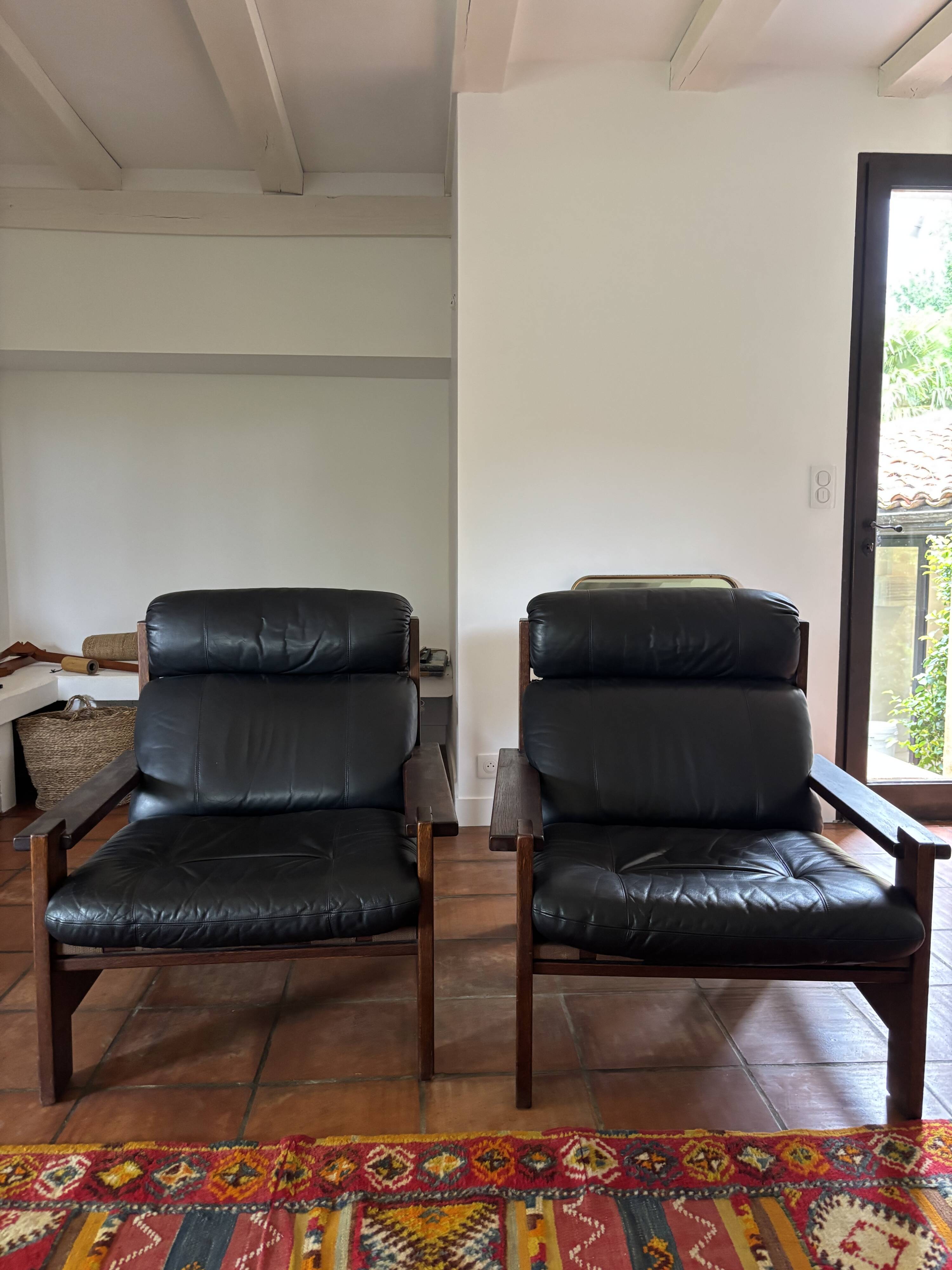 Vintage Scandinavian armchairs in leather and solid wood.