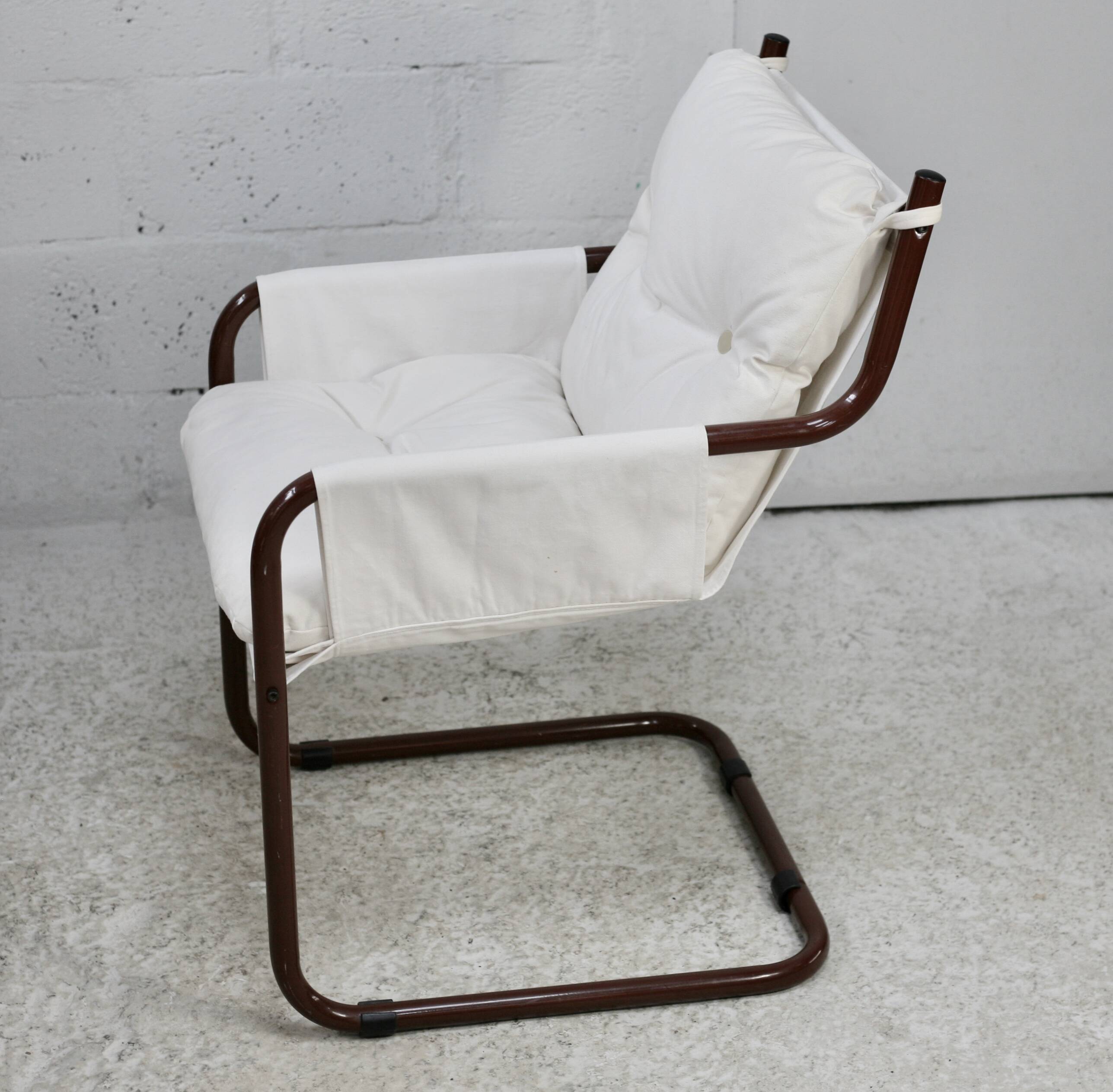 Tubular armchair, fabric suspended seat. Circa 1970