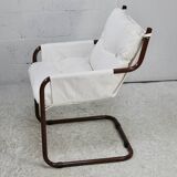 Tubular armchair, fabric suspended seat. Circa 1970