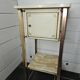 Bedside table in patinated iron, brass and marble tops