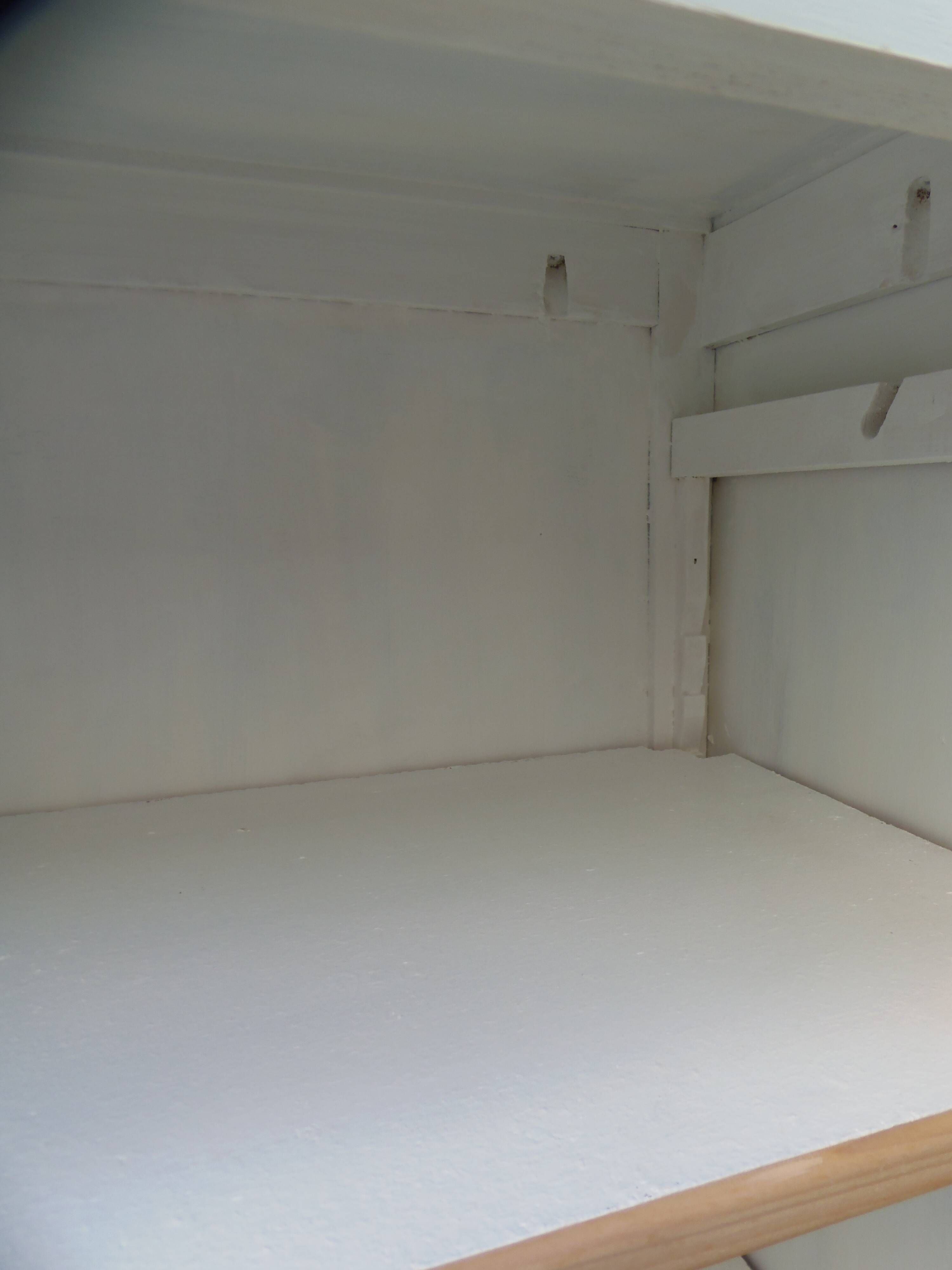 Vintage beige wardrobe made of wood and jute fabric.