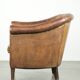 Vintage sheepskin club armchair finished with decorative nails