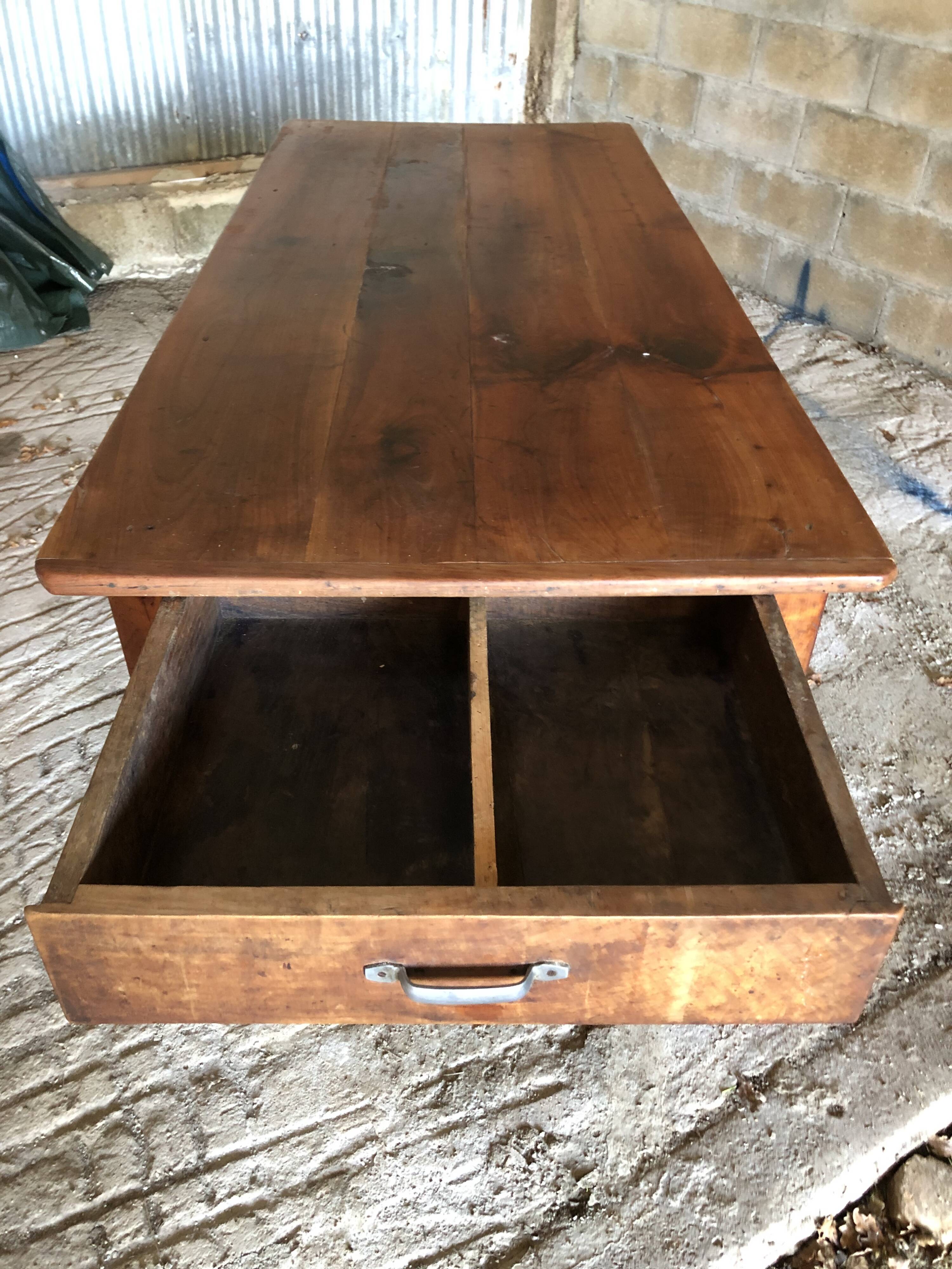 Antique Louis Philippe style farm table in solid cherry wood with turned base.