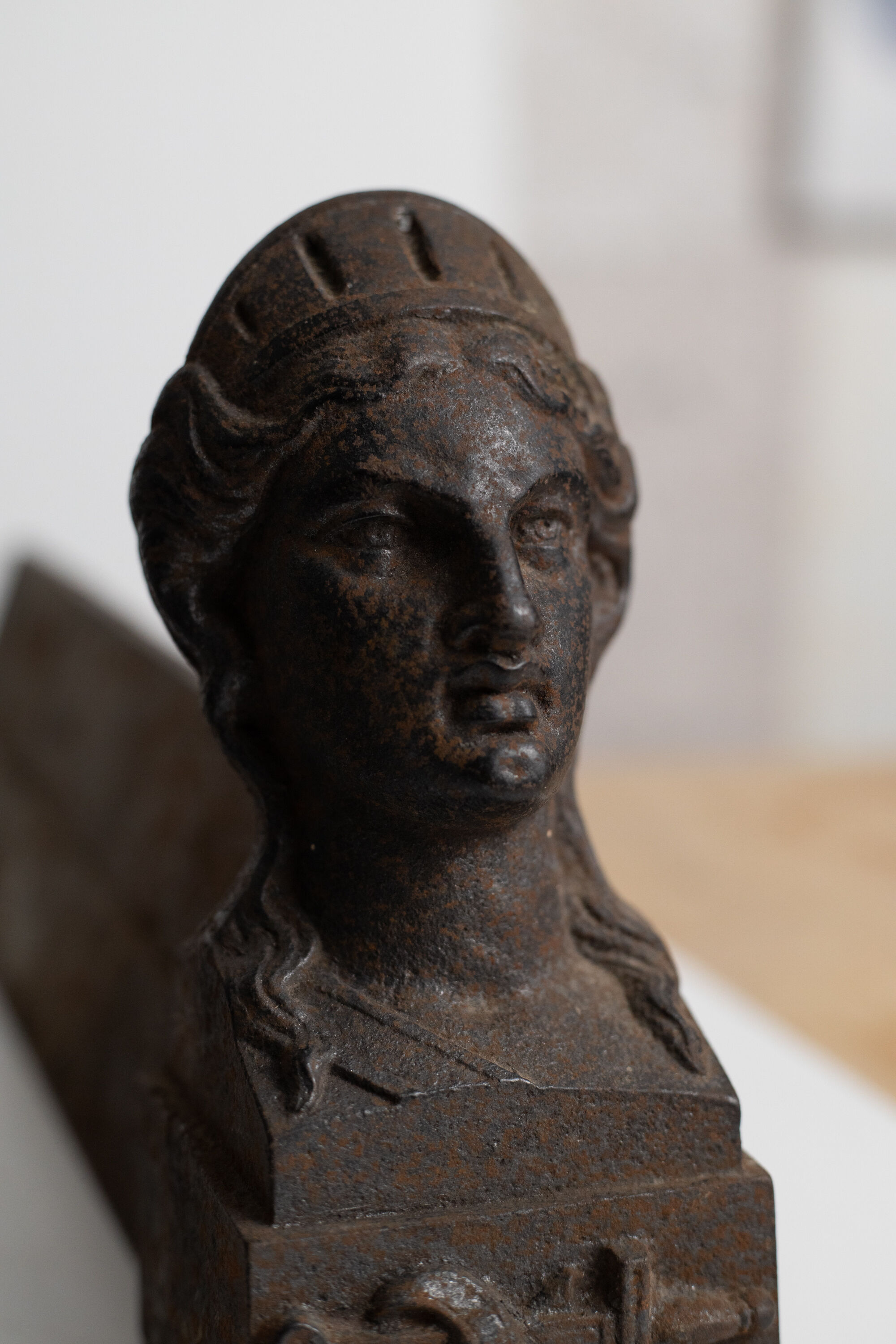 Pair of ancient cast iron chenets adorned with bust of Marianne