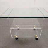End of sofa with glass and plexiglass wheels from the 70s
