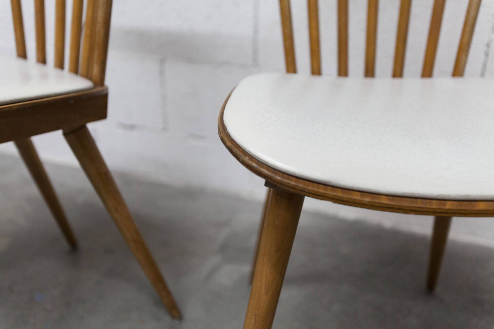 Pair of Baumann Menuet chairs, Honey patina, White skai seat