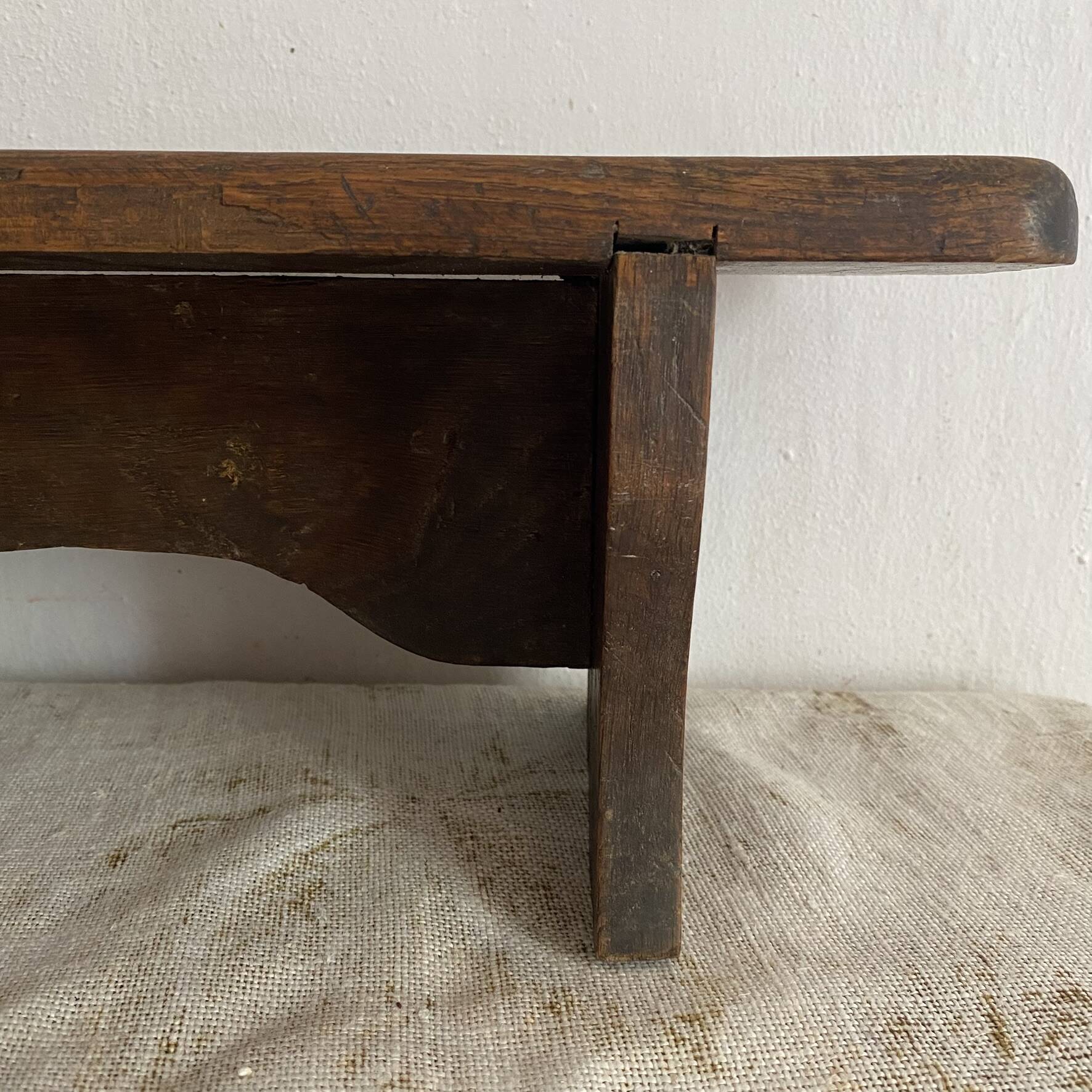 Old low stool made of solid wood