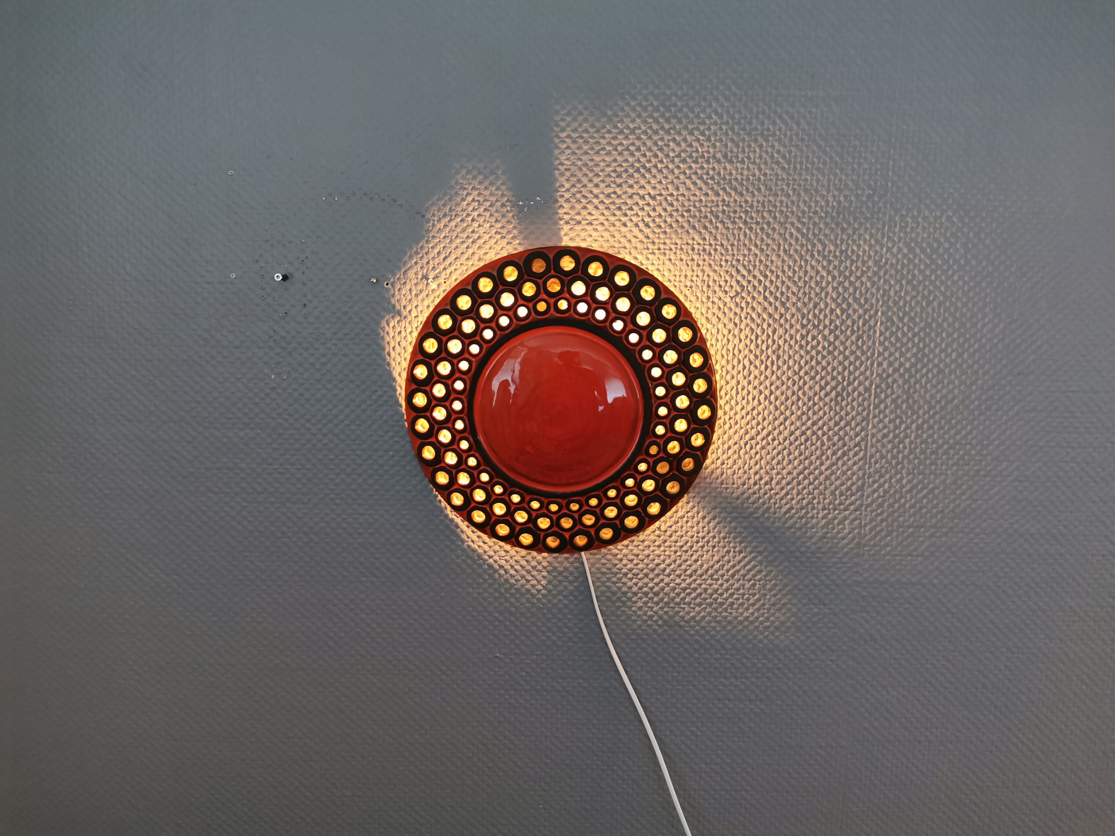 Wall light made from brown and red ceramic. Signed Norman Motala Sweden 1970s.
