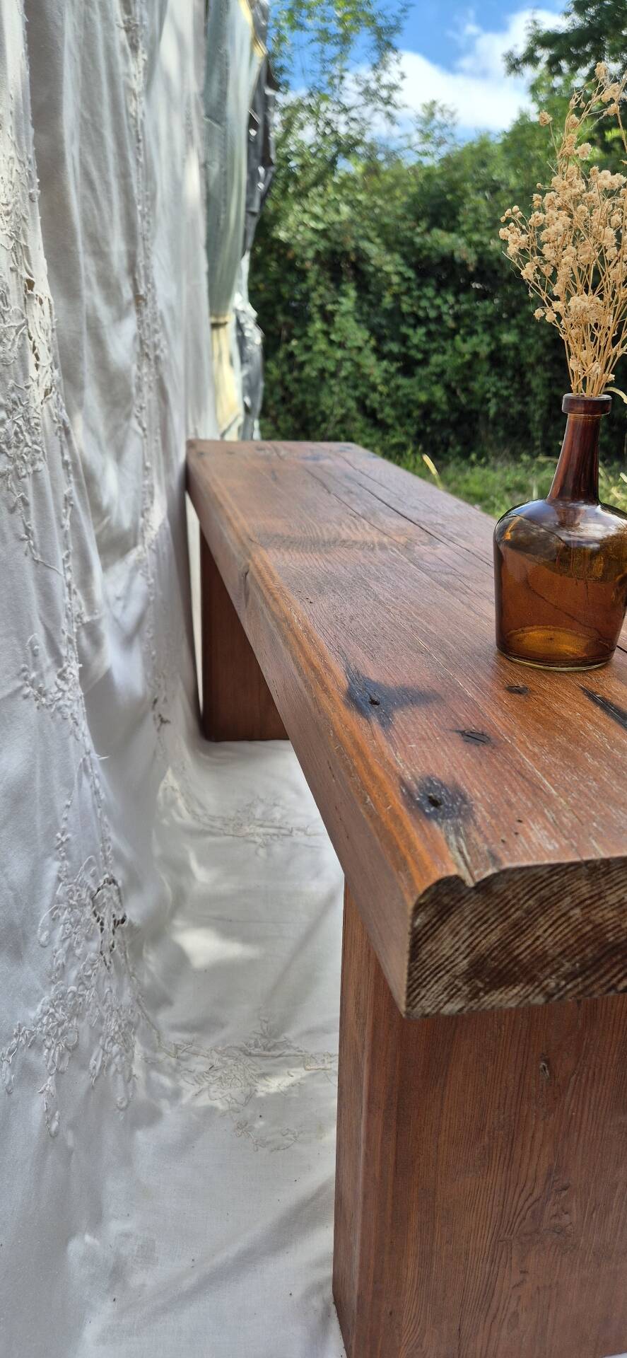 Brutalist wooden bench made of solid oak beam.