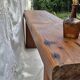 Brutalist wooden bench made of solid oak beam.