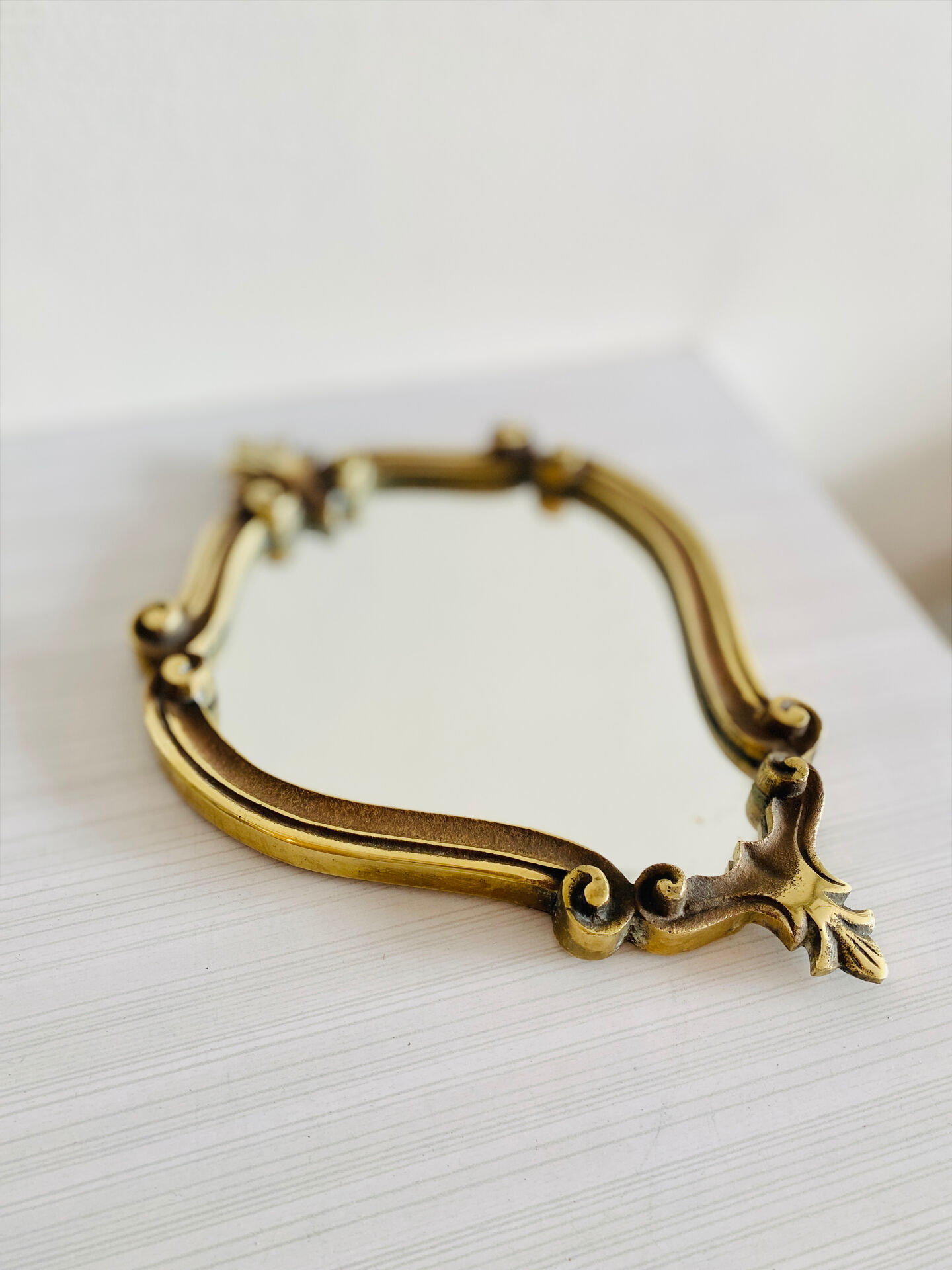 Small antique mirror in baroque style – gold frame in bronze or brass.