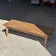 Brown Indonesian teak coffee table, with a border and cylindrical legs H40 L103.