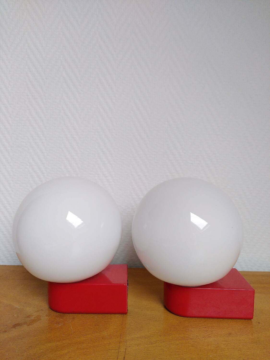 2 postmodern opaline and red metal wall lights, 1980