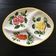 Serving platter decorated with fruits and vegetables.