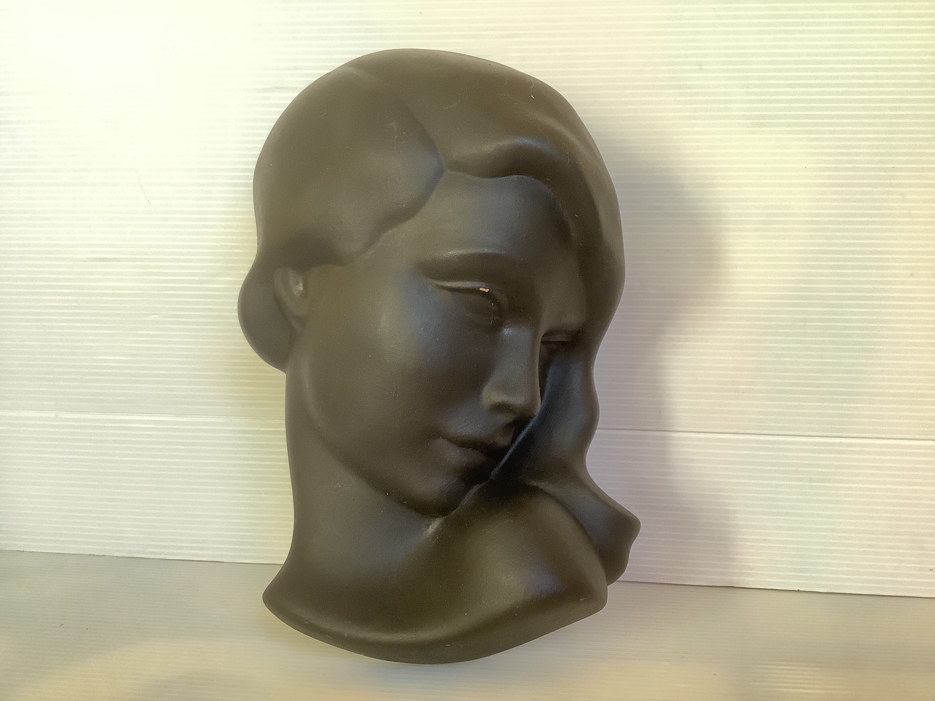 Bust head of a young woman in terracotta