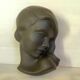 Bust head of a young woman in terracotta