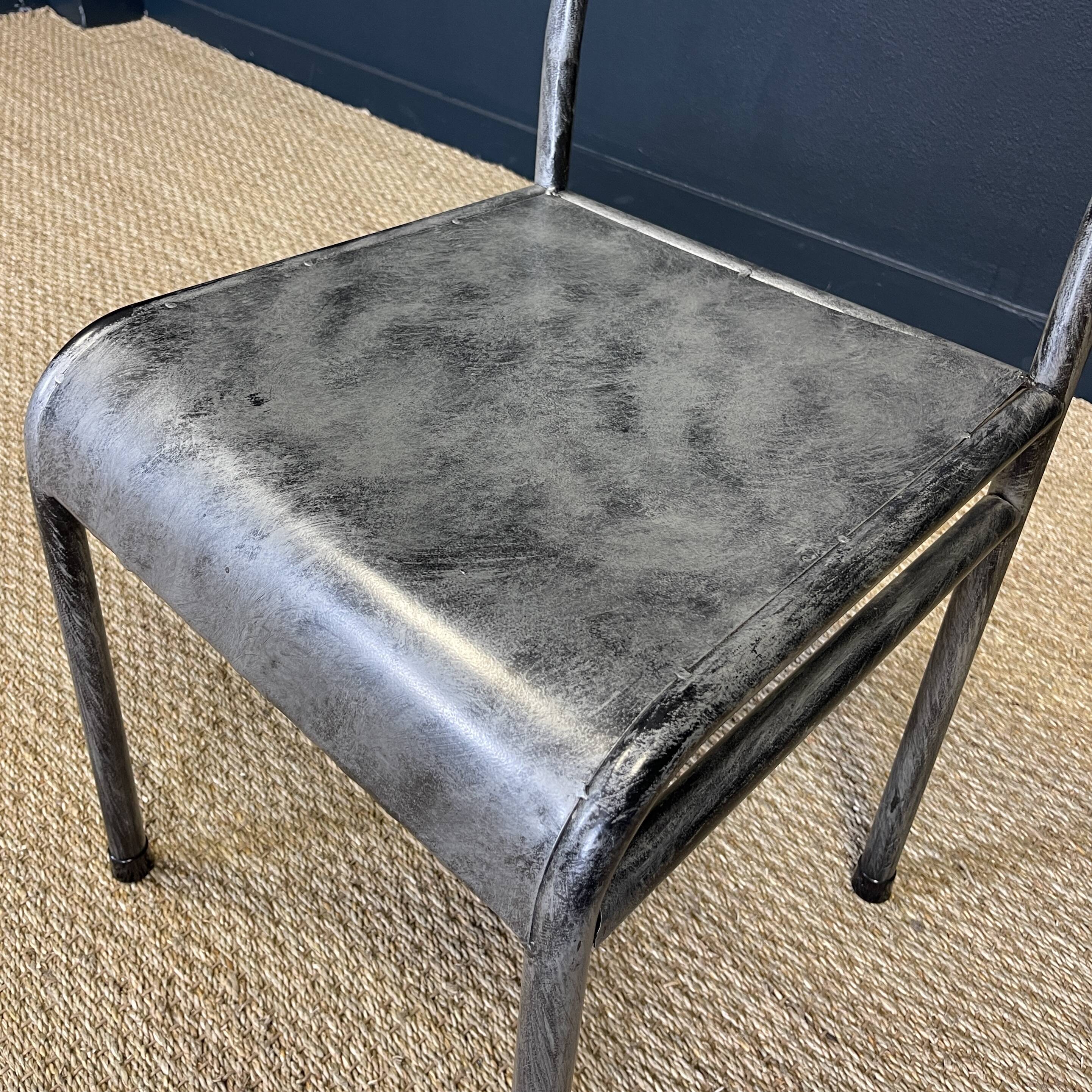 Pair of gray metal industrial chairs