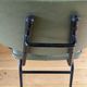 Vintage chair with green imitation leather armrests