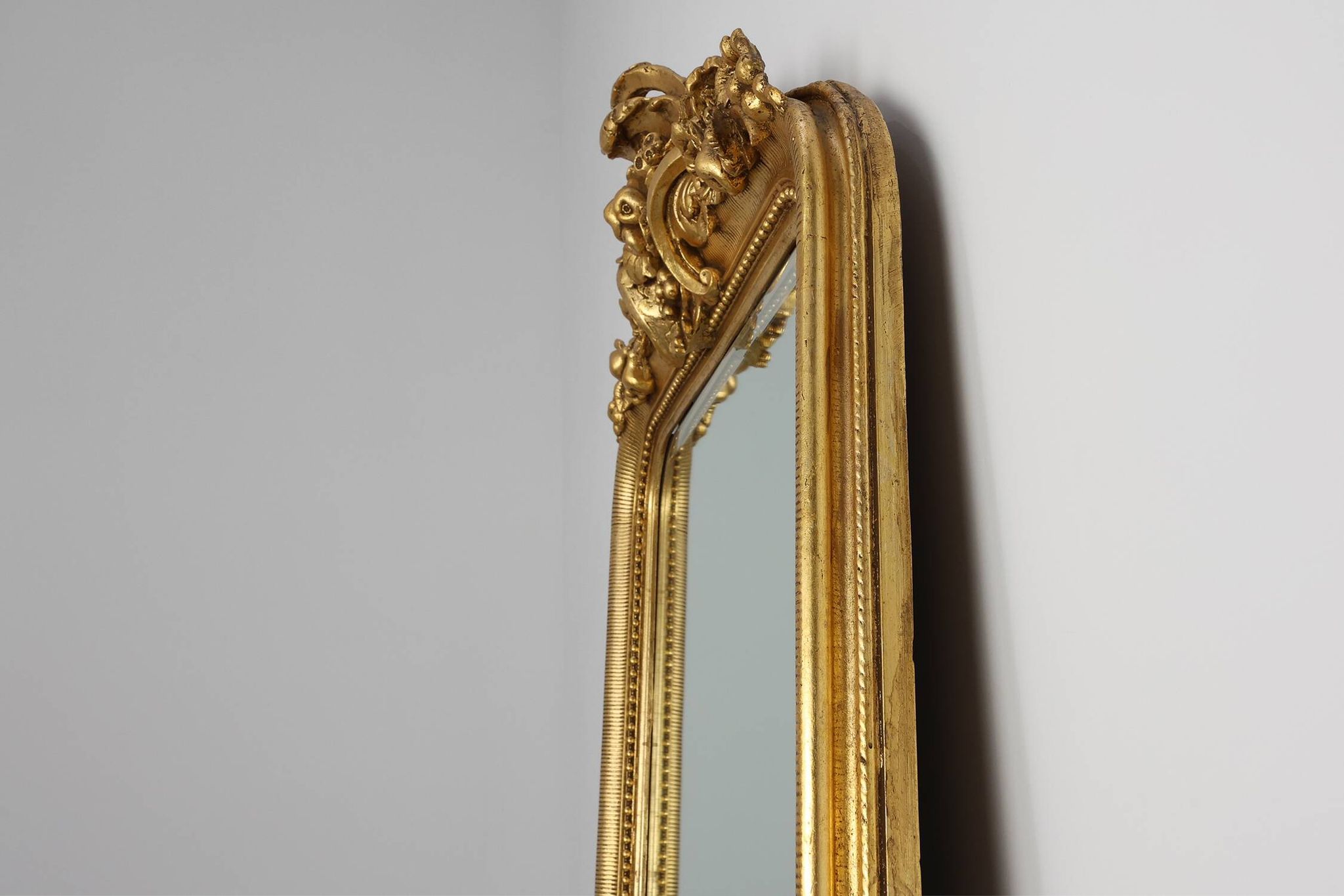 Baroque mantel mirror in carved wood and gilded plaster, France circa 1850.