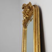 Baroque mantel mirror in carved wood and gilded plaster, France circa 1850.
